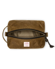 Light brown travel bag with Filson logo against a white background. 