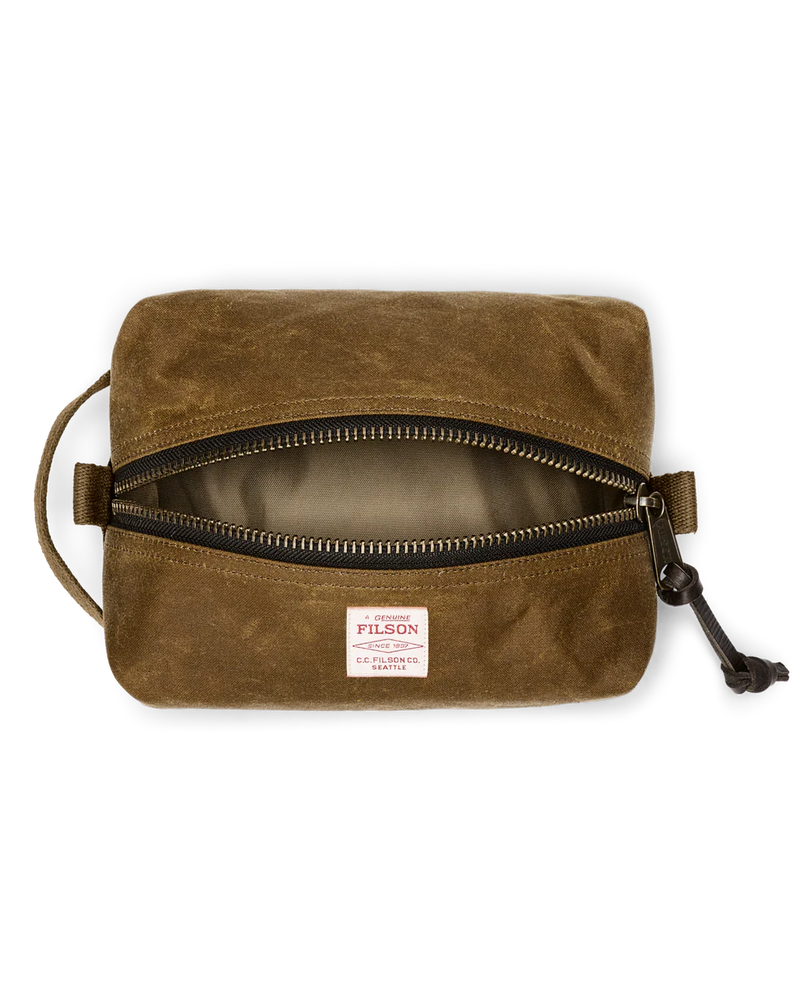 Light brown travel bag with Filson logo against a white background. 