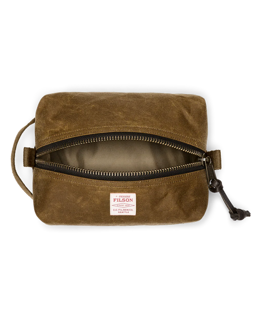 Light brown travel bag with Filson logo against a white background. 
