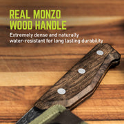 Handle of a Nakiri knife resting on a table with a text in the upper left corner that reads "Real monzo wood handle; extremely dense and naturally water-resistant for long lasting durability."