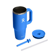 A blue Hydro Flask travel tumbler with a handle, shown with its lid, straw, and straw insert on a clean white background.