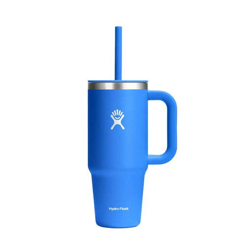 A blue Hydro Flask tumbler with a handle, matching blue straw, and a silver rim, shown on a plain white background.