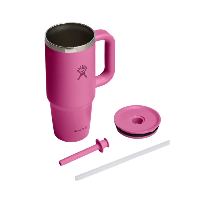 A pink Hydro Flask travel tumbler with a handle, shown with its lid, straw, and straw cap on a clean white background.