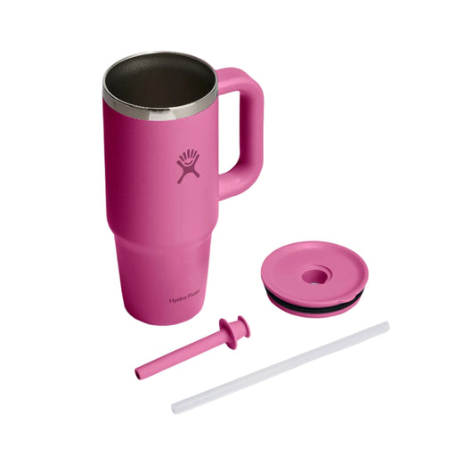 A pink Hydro Flask travel tumbler with a handle, shown with its lid, straw, and straw cap on a clean white background.