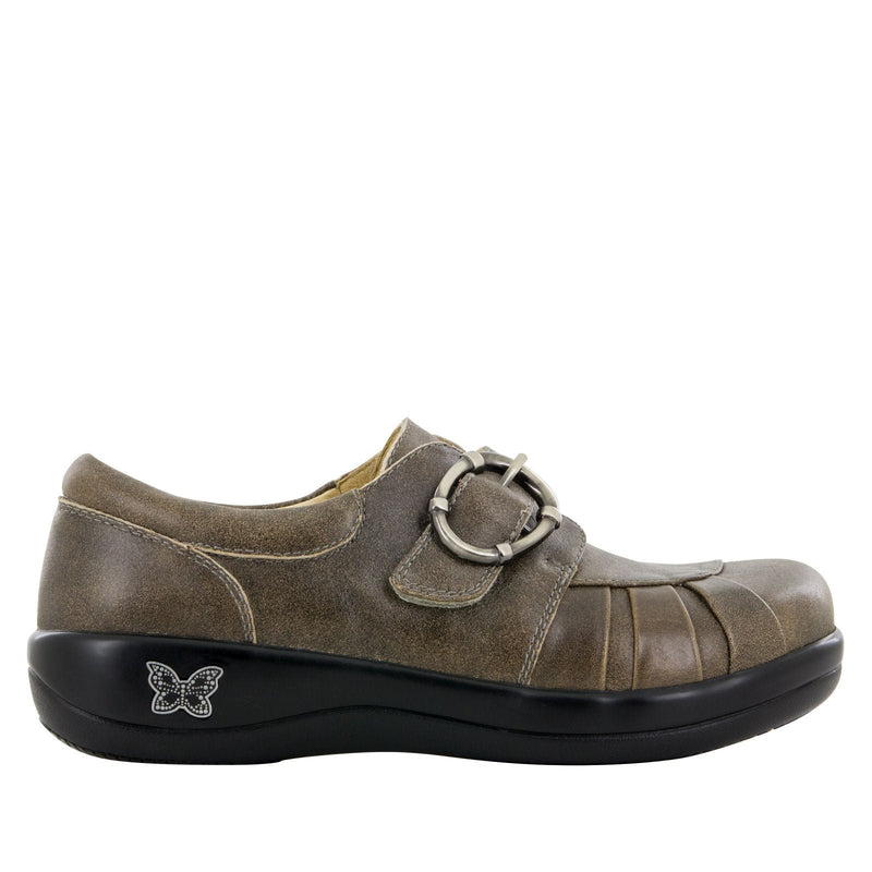 Brown shoe with a buckle on a white background