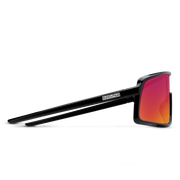 The side view of a pair of black glasses with red lenses on a white background