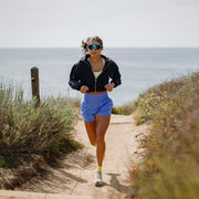 A person running outside wearing a pair of sunglasses with blue lenses
