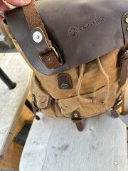 Brown leather bag with visible brand logo on a metal surface