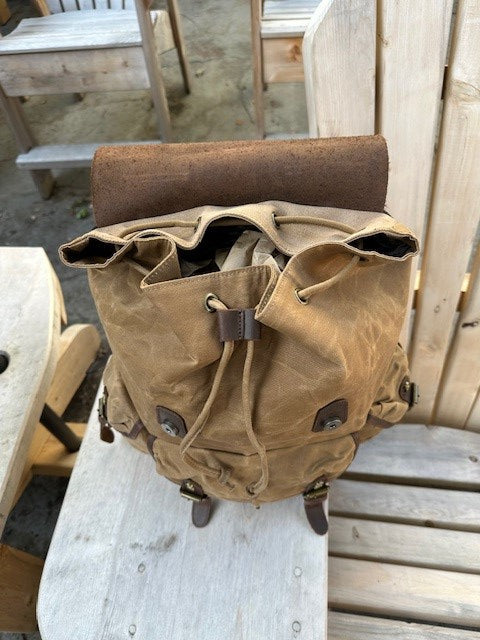 Brown leather bag on a wooden surface
