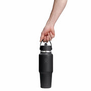 Person holding a black water bottle with a white background
