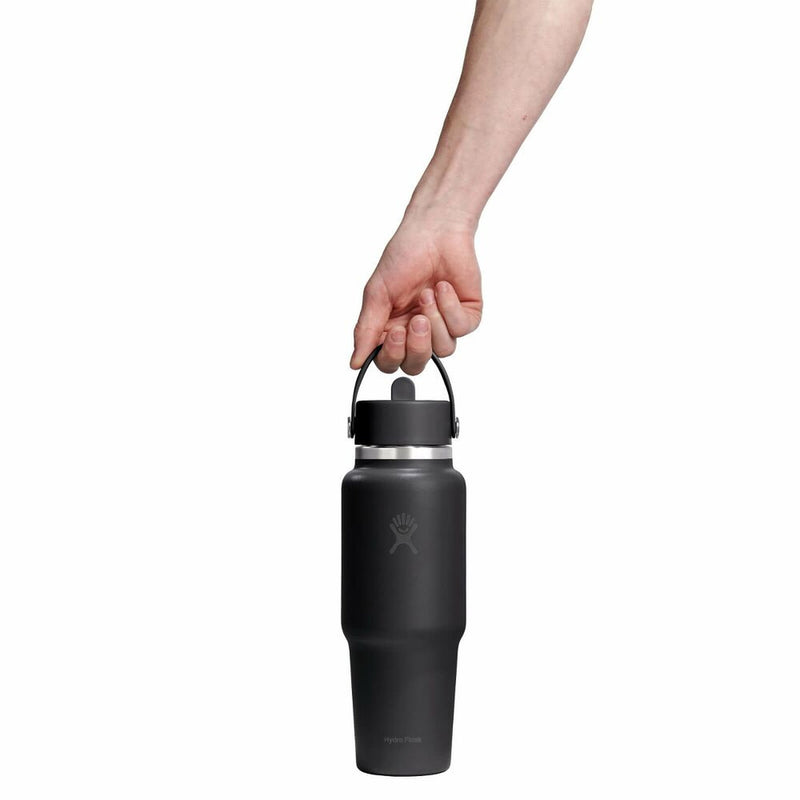 Person holding a black water bottle with a white background