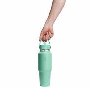 Mint green water bottle with handle held by a hand on a white background