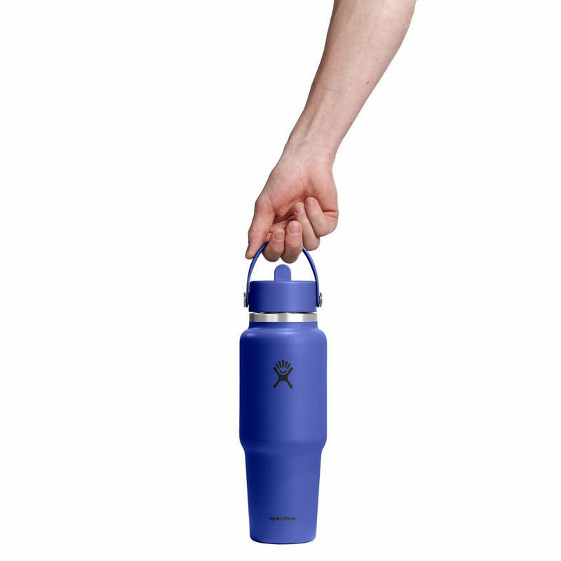 Blue water bottle held by a hand on a white background
