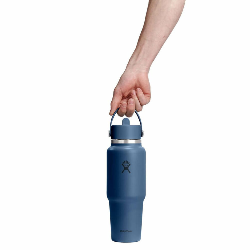Blue insulated bottle held by a hand on a white background