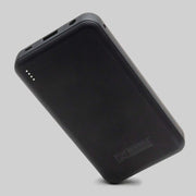 Black portable battery pack on a gray background