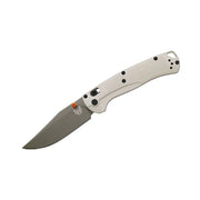 Folding knife with a beige handle on a white background