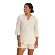 Woman wearing a beige shirt and shorts on a white background